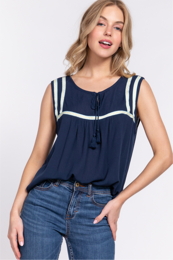 SLEEVELESS ROUND NECK WITH TASSEL STRING EMBROIDERED TAPE TRIMMED WOVEN TOP